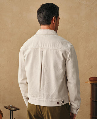 Natural twill jacket back view with center seam and stand collar detail.