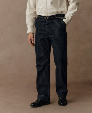 Indigo herringbone denim work pants with pleated waist and straight-leg fit