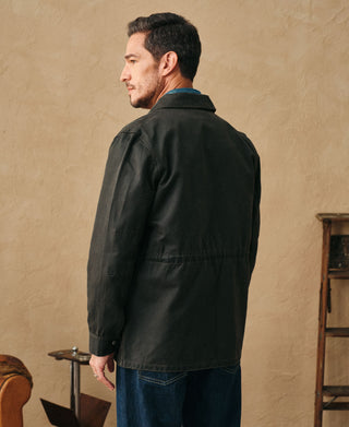 Black olive field jacket back view with button closure and stand collar