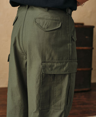 Olive cargo pants side with flap pocket and vertical utility pocket