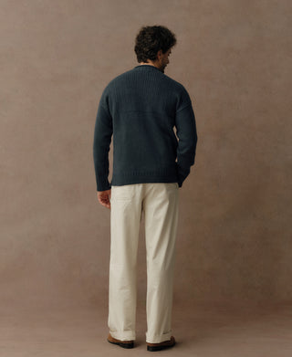 Dark blue pure wool Guernsey sweater with mock neck, ribbed cuffs and hem, shown from the back