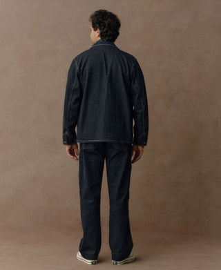 Indigo herringbone denim work jacket, back view with button closure