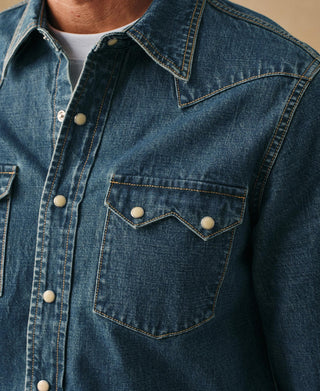 Light blue denim western shirt with pointed yoke, snap front, and chest flap pocket