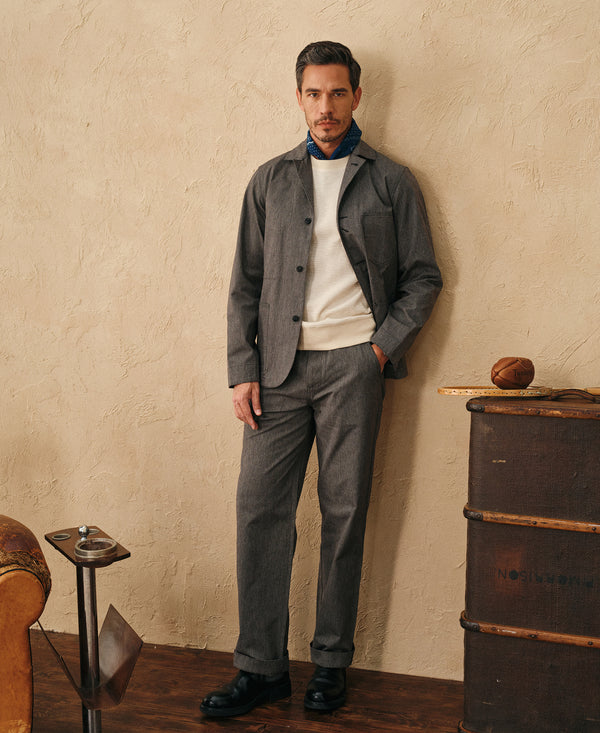 Black chambray work jacket worn by model, front view with buttoned lapel