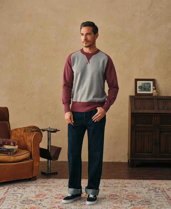 Crewneck sweatshirt in light gray with plum red raglan sleeves and contrast hem (front full).