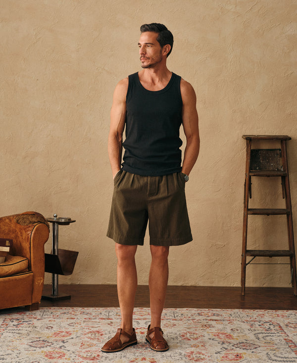 Black ribbed sleeveless tank top worn by a man, front view
