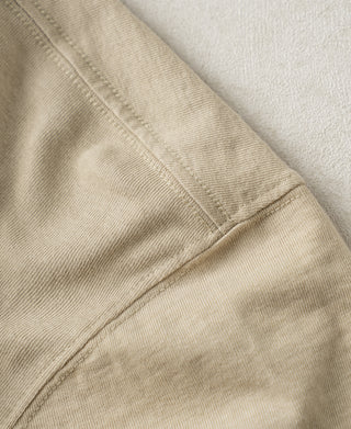 Apricot slub cotton T-shirt sleeve seam close-up