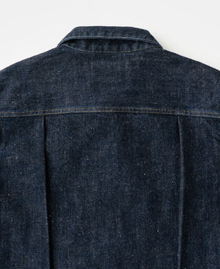 The back of a dark indigo type 1 denim jacket, showing the collar, shoulder seam, and back panel stitching.